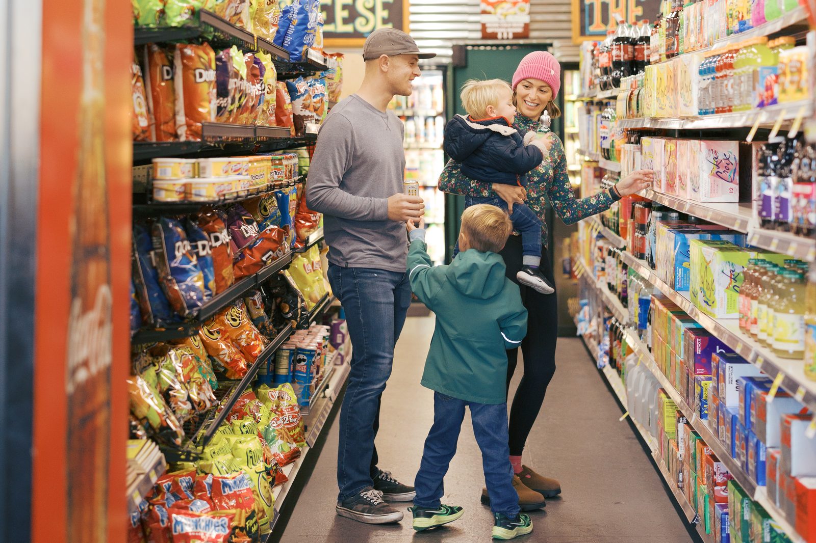 Family browsing the snack aisle together on a grocery store date