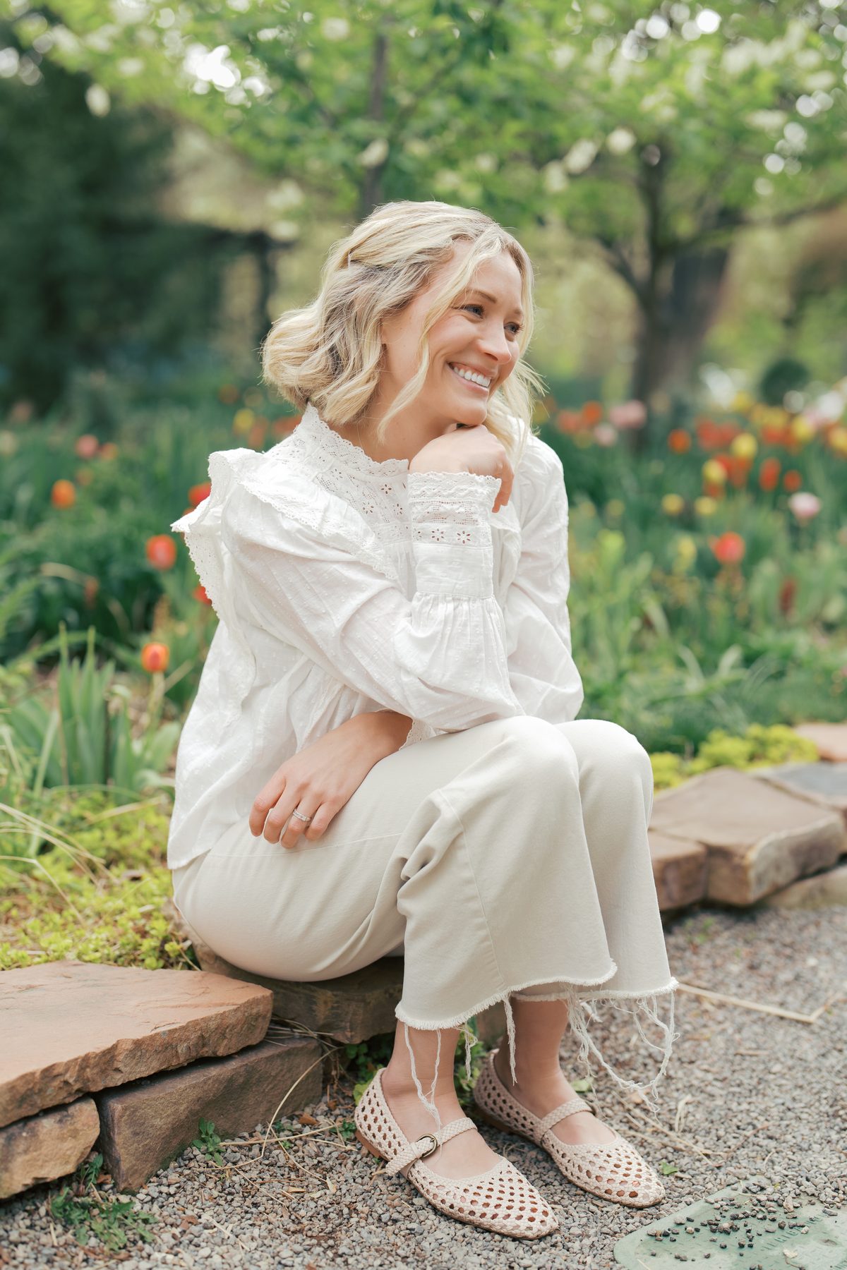 Sami Norton, Utah family photographer, smiling in a spring tulip garden